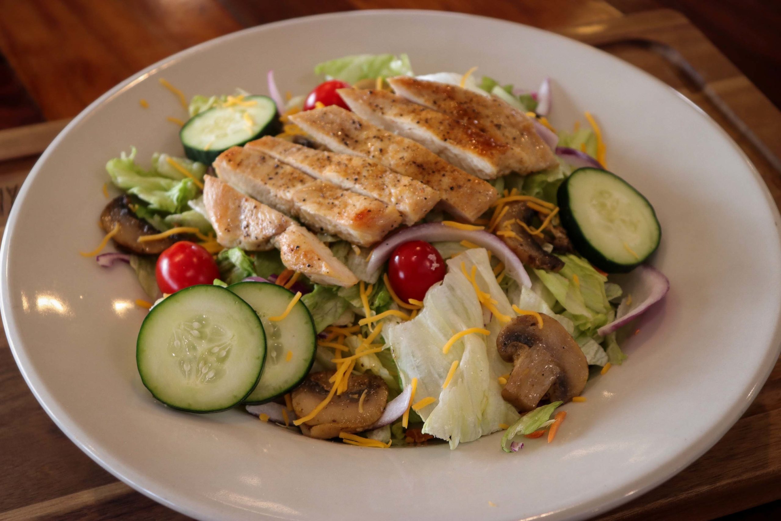 salad with cucumbers, mushrooms, tomatoes and chicken