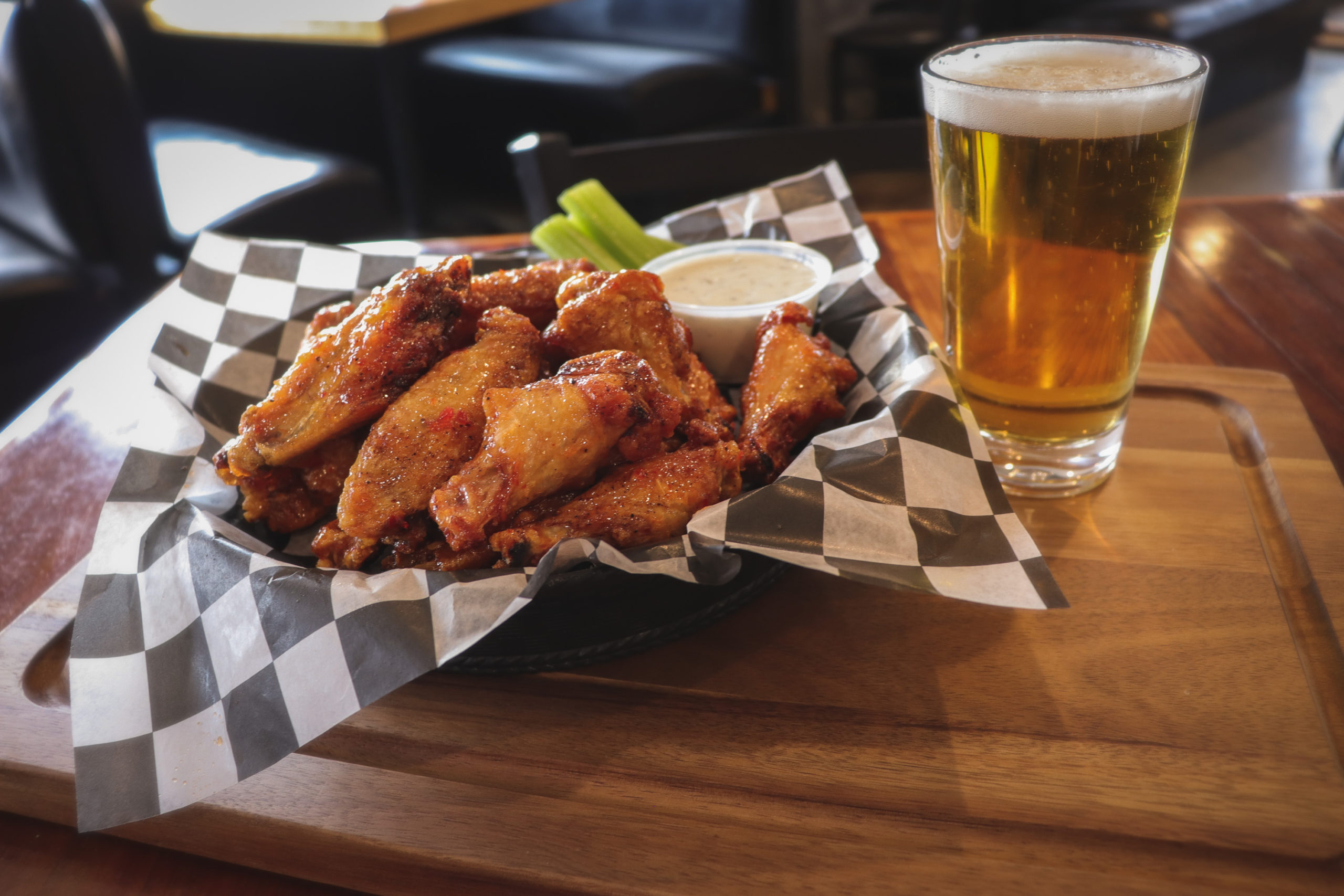 chicken wings in basket with a beer