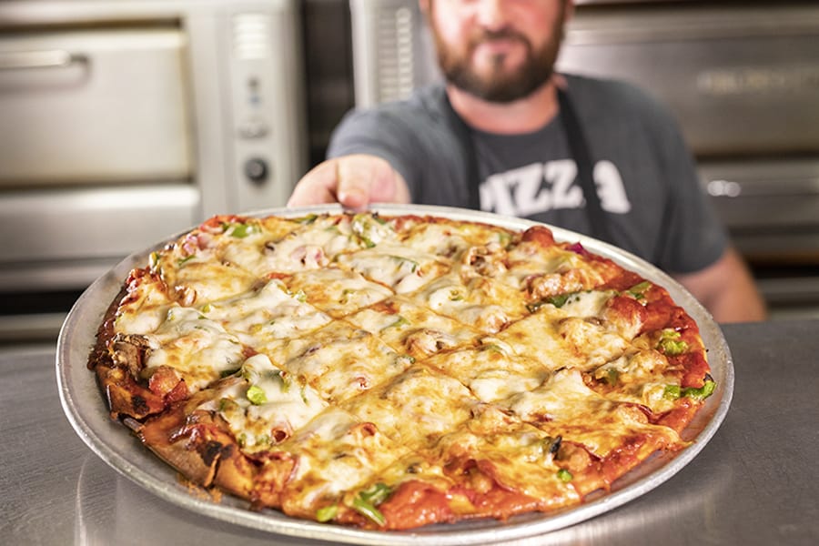 Man holding delicious pizza